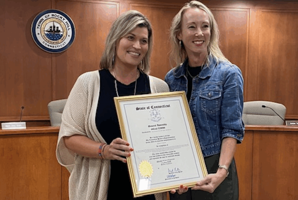 A blond woman recieving an award